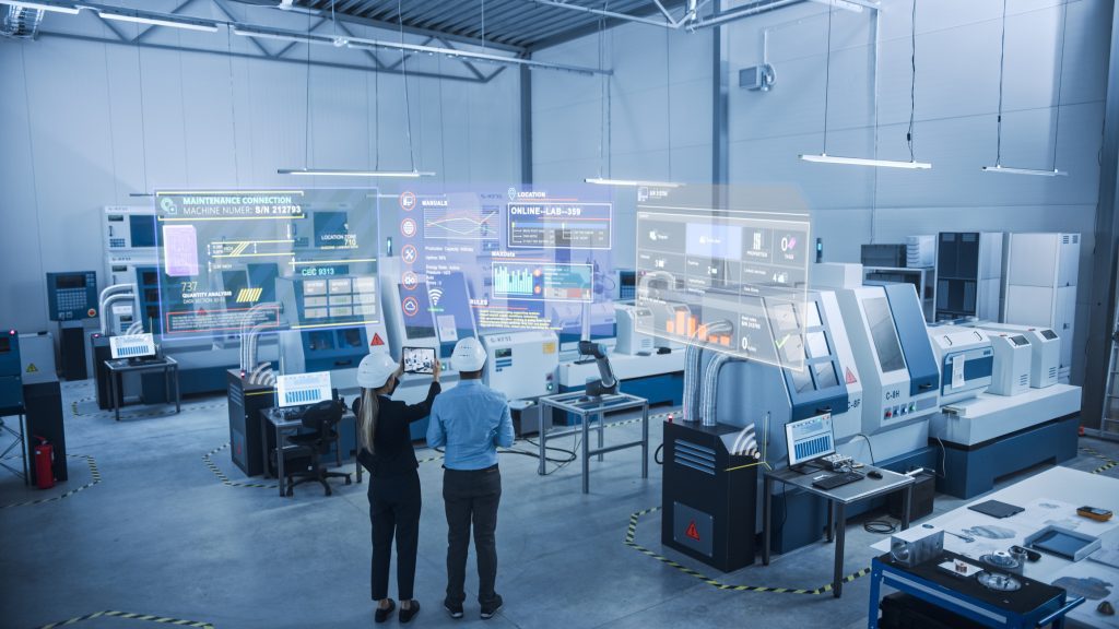 Man and woman using SAP solutions at work in manufacturing environment
