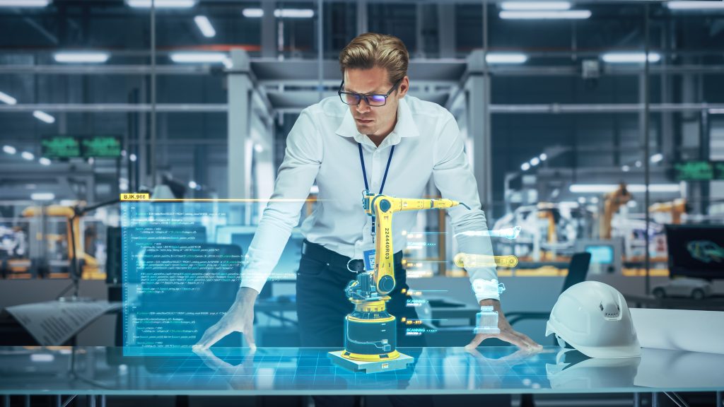 Man at manufacturing facility office envisioning high tech machines