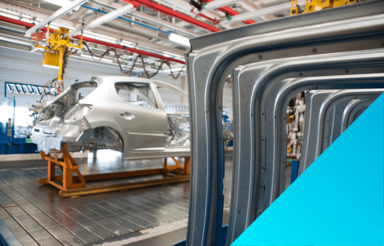 automotive digital manufacturing machines working on a vehicle frame.