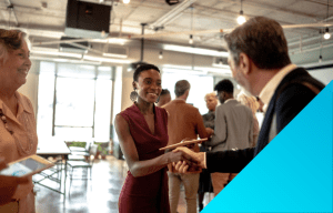 woman shaking man's hand at a networking event.
