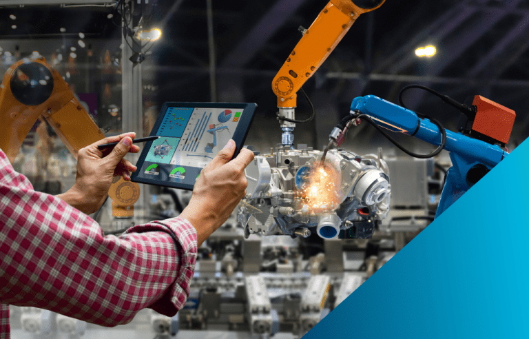 A close-up of a person's hands holding a tablet and stylus, monitoring two industrial robot arms that are welding a mechanical part on a factory floor.