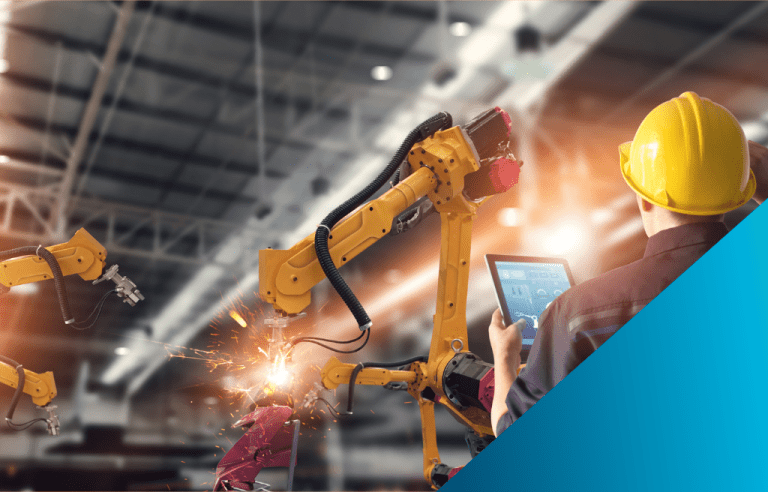 A worker wearing a yellow hard hat holding a tablet with a data overlay of the mechanical arms operating in front of him.