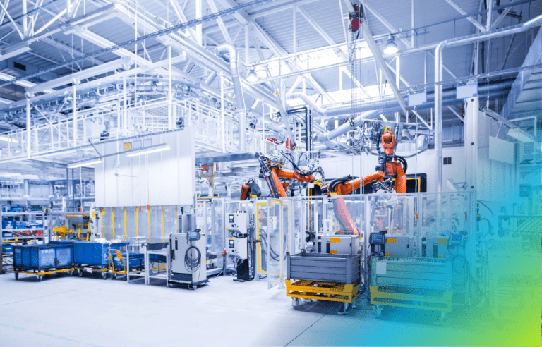Modern automated factory floor with several large orange robotic arms in a manufacturing cell.